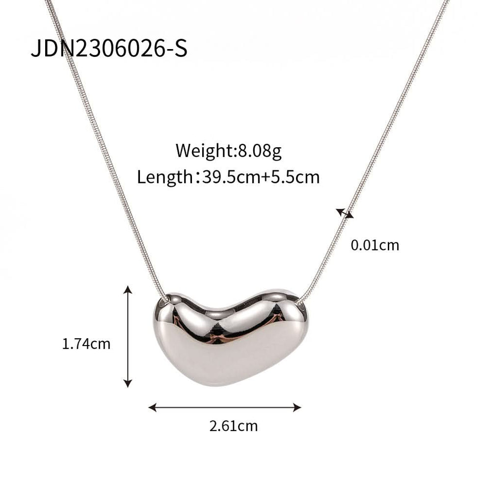 Bean pendant layered with other necklaces