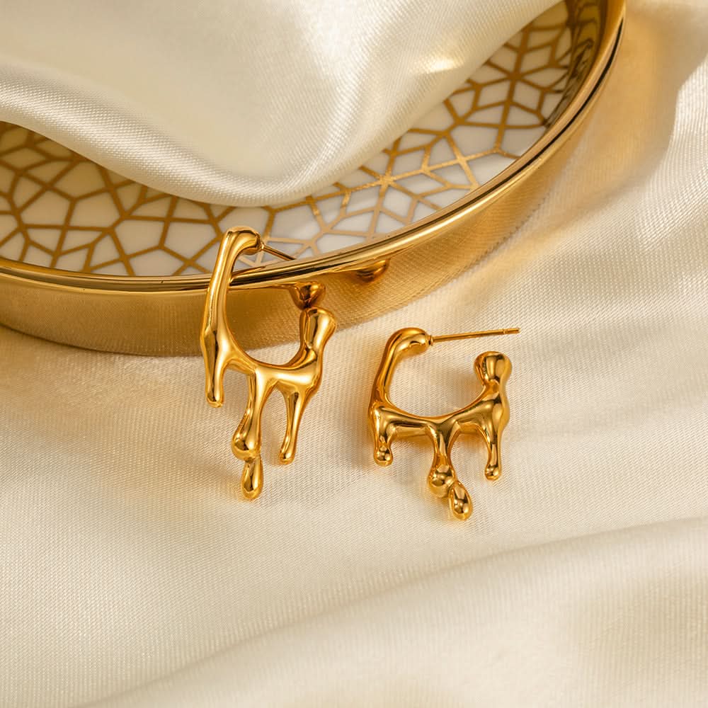 Molten drip earrings flat lay on white