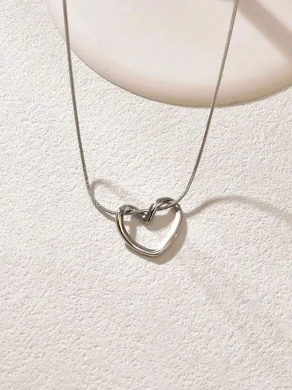 Hollow heart pendant necklace side angle view