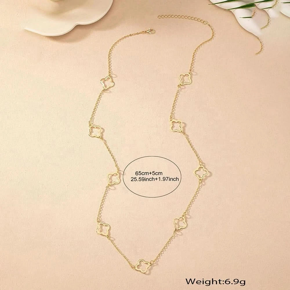 Gold clover necklace worn on model