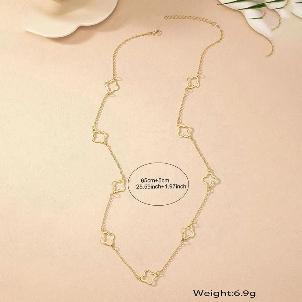 Gold clover necklace worn on model