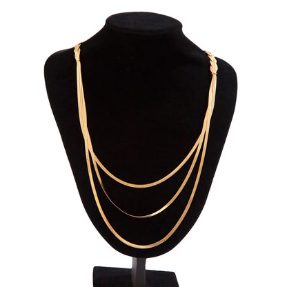 Gold necklace draped on collarbone