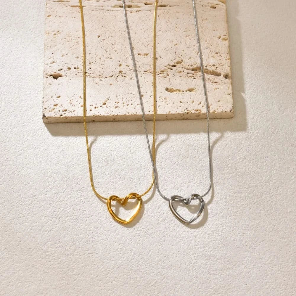 Hollow heart pendant necklace shown at collarbone length