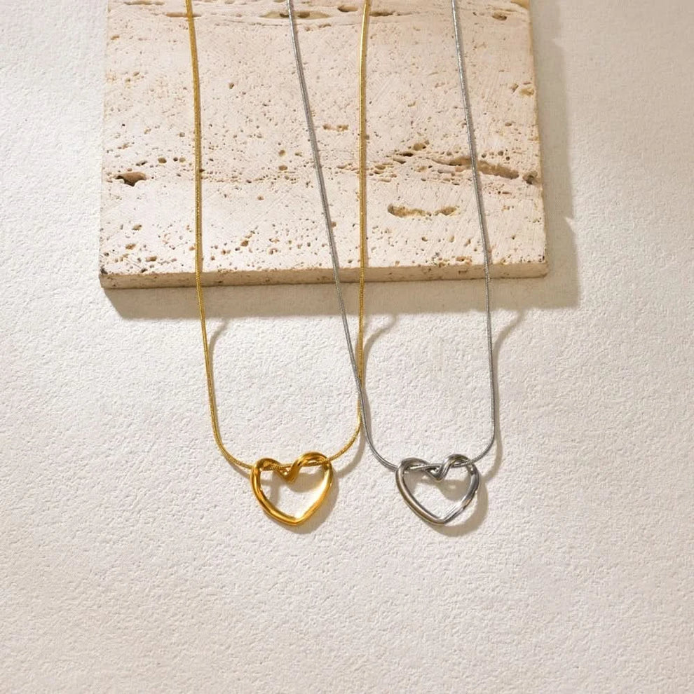 Hollow heart pendant necklace shown at collarbone length