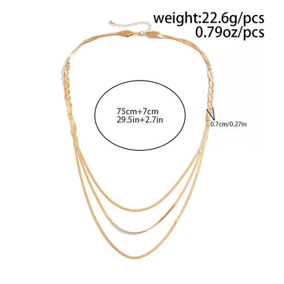 Braided gold necklace worn on model