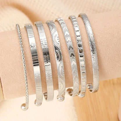 Bangle set in gold finish on wrist