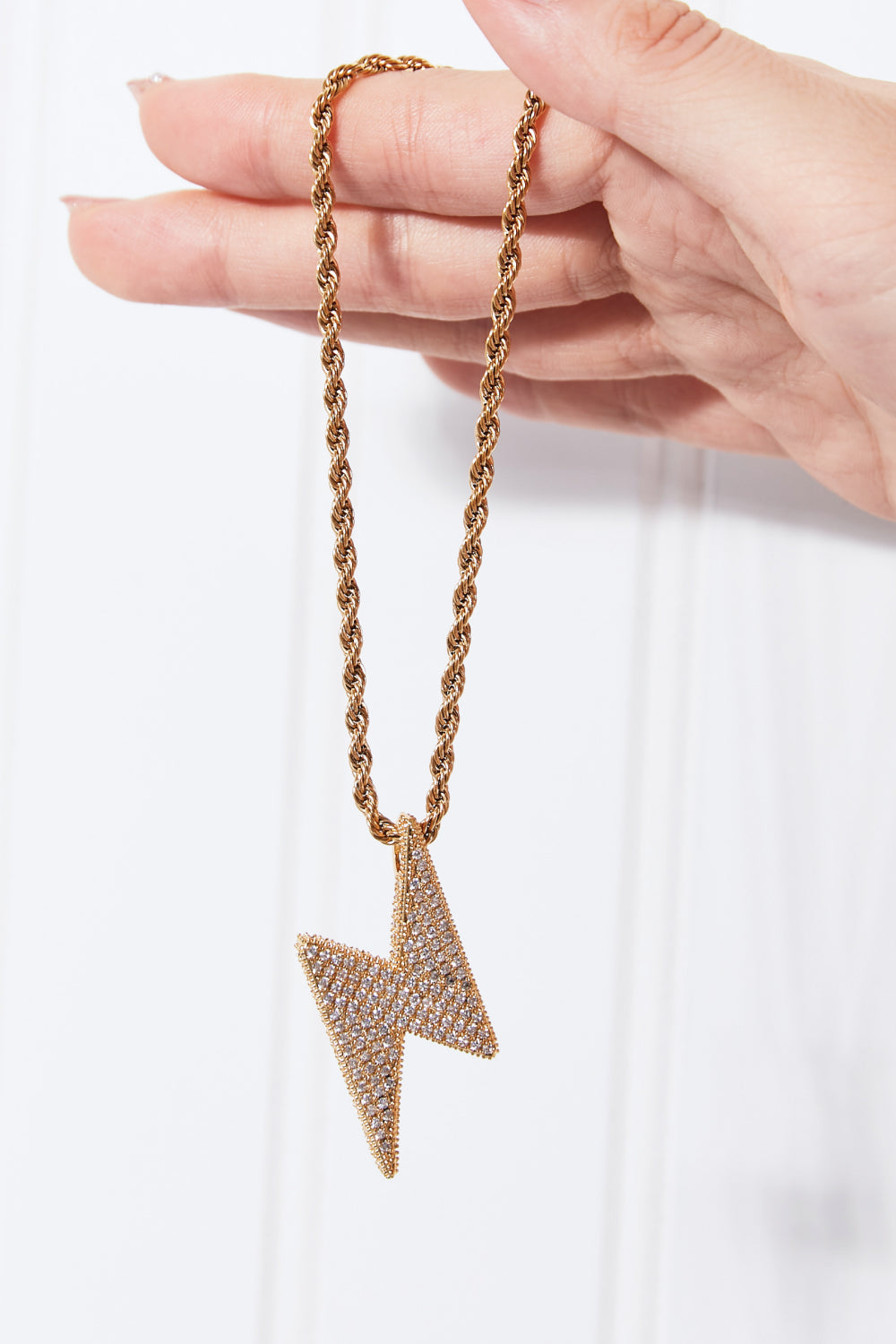Lightning pendant on twisted brass chain detail